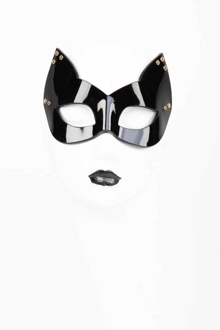 Black cat mask with gold accents on a white background